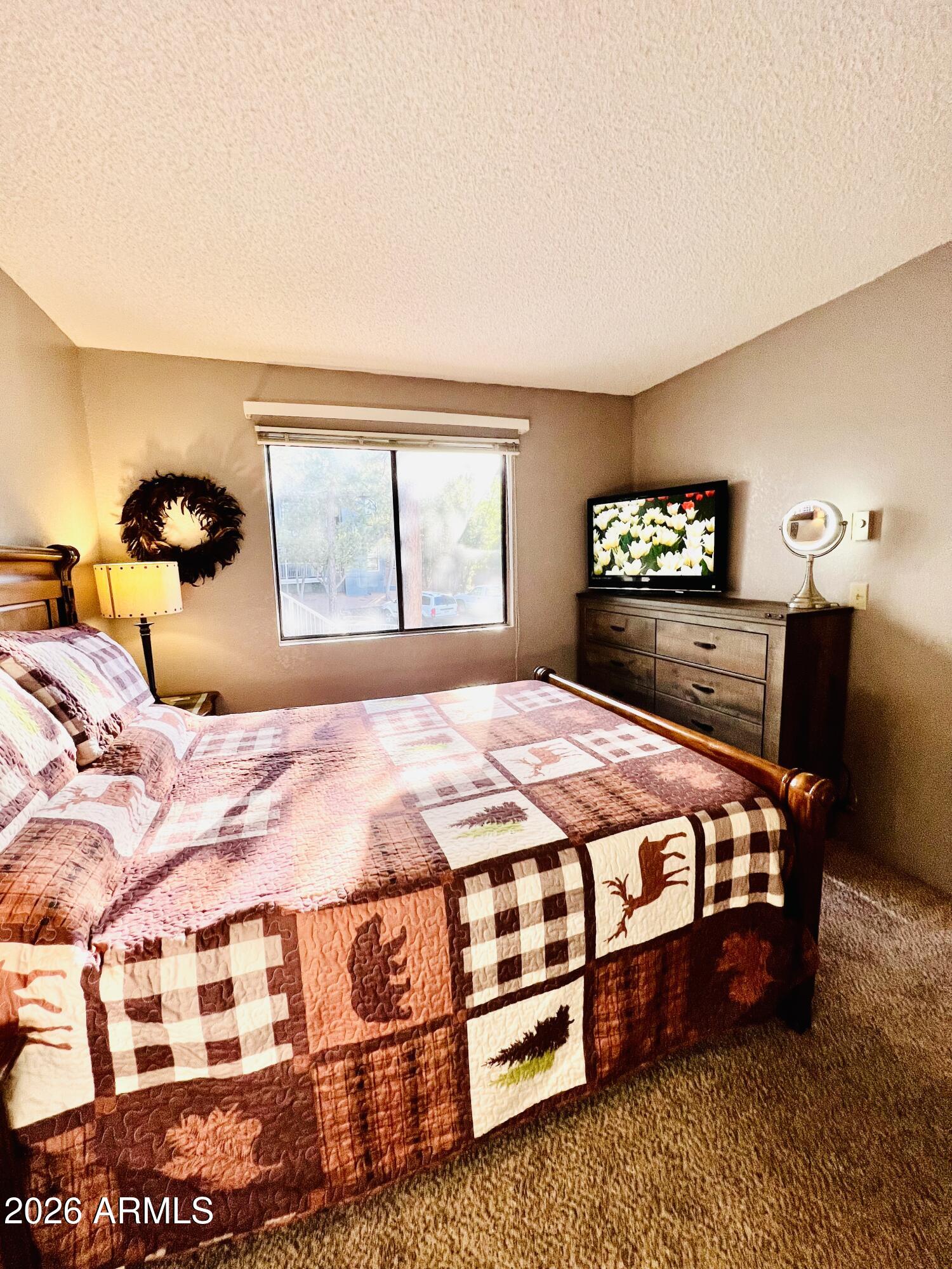 2700 South White Mountain Road, Unit 1126 Show Low, AZ 85901 - Photo 15 of 32 a bedroom with a bed lamp closet and window