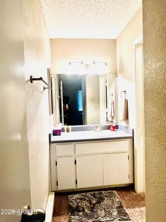 a view of a bathroom with a sink and mirror