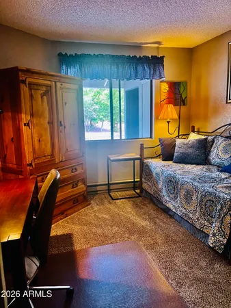 a living room with a couch and a potted plant