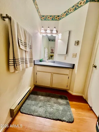 a bathroom with a sink mirror vanity and toilet