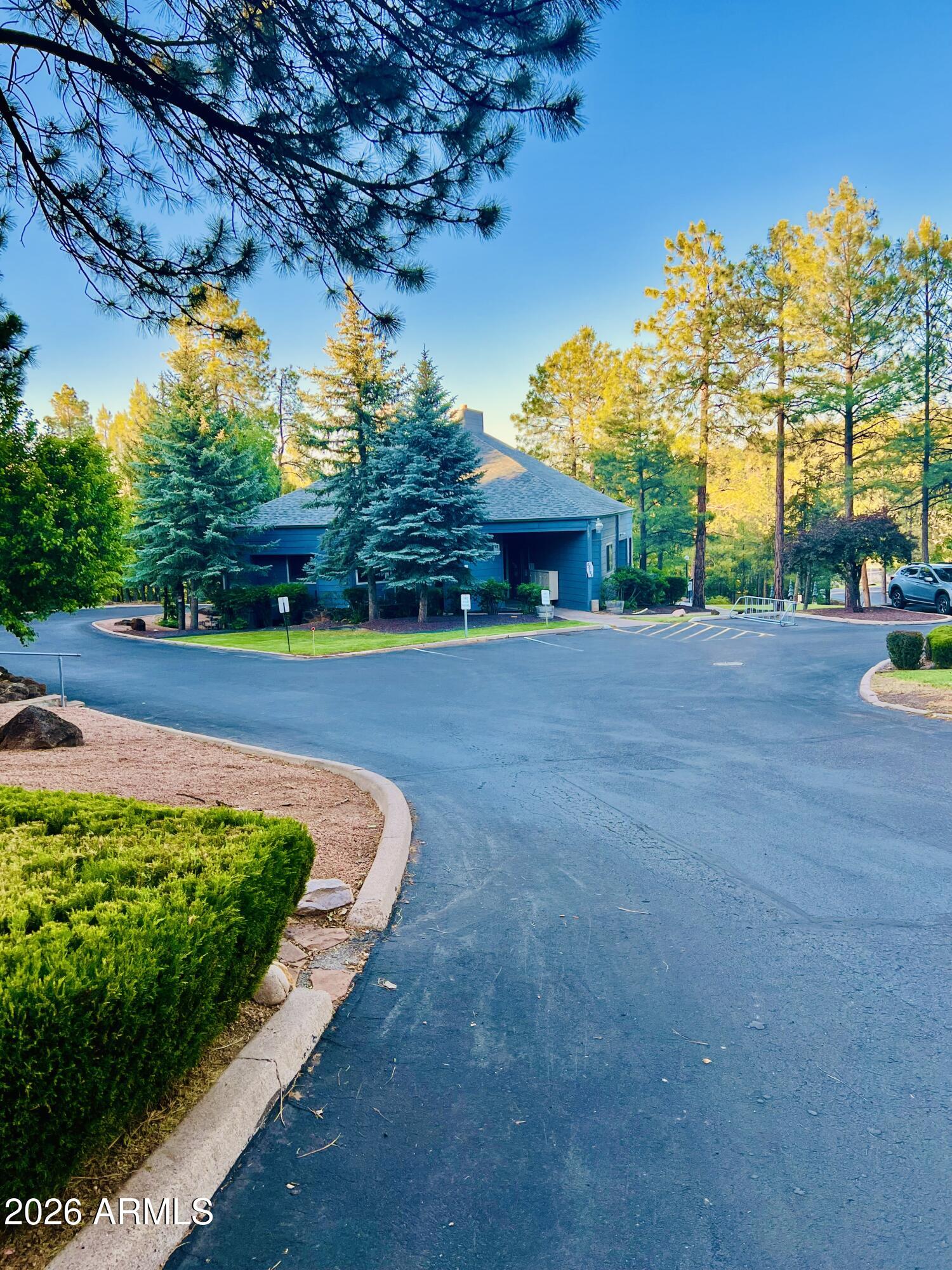 2700 South White Mountain Road, Unit 1126 Show Low, AZ 85901 - Photo 27 of 32 a view of a house with a big yard and potted plants