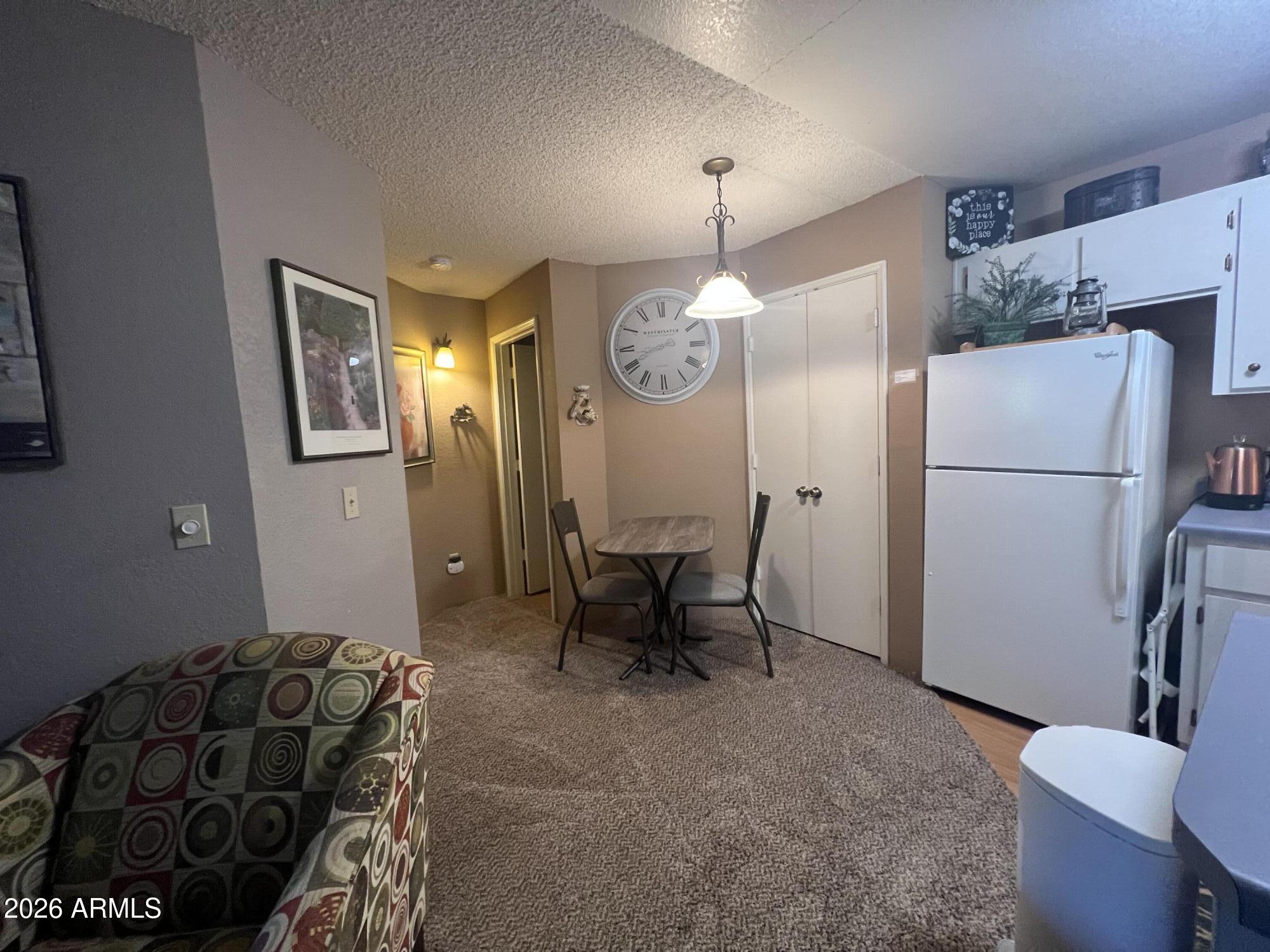 2700 South White Mountain Road, Unit 1126 Show Low, AZ 85901 - Photo 29 of 32 a living room with furniture a table and a chairs