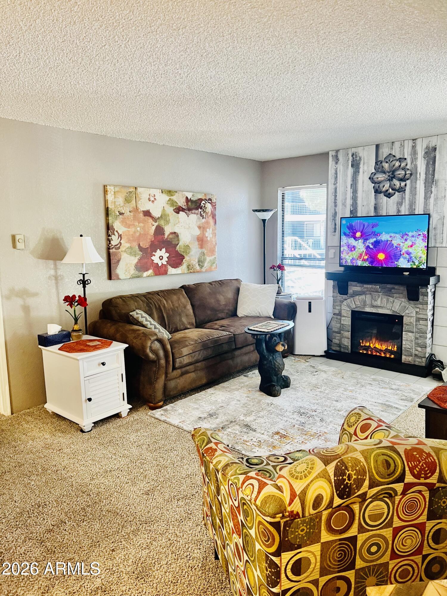 2700 South White Mountain Road, Unit 1126 Show Low, AZ 85901 - Photo 30 of 32 a living room with furniture and a fireplace