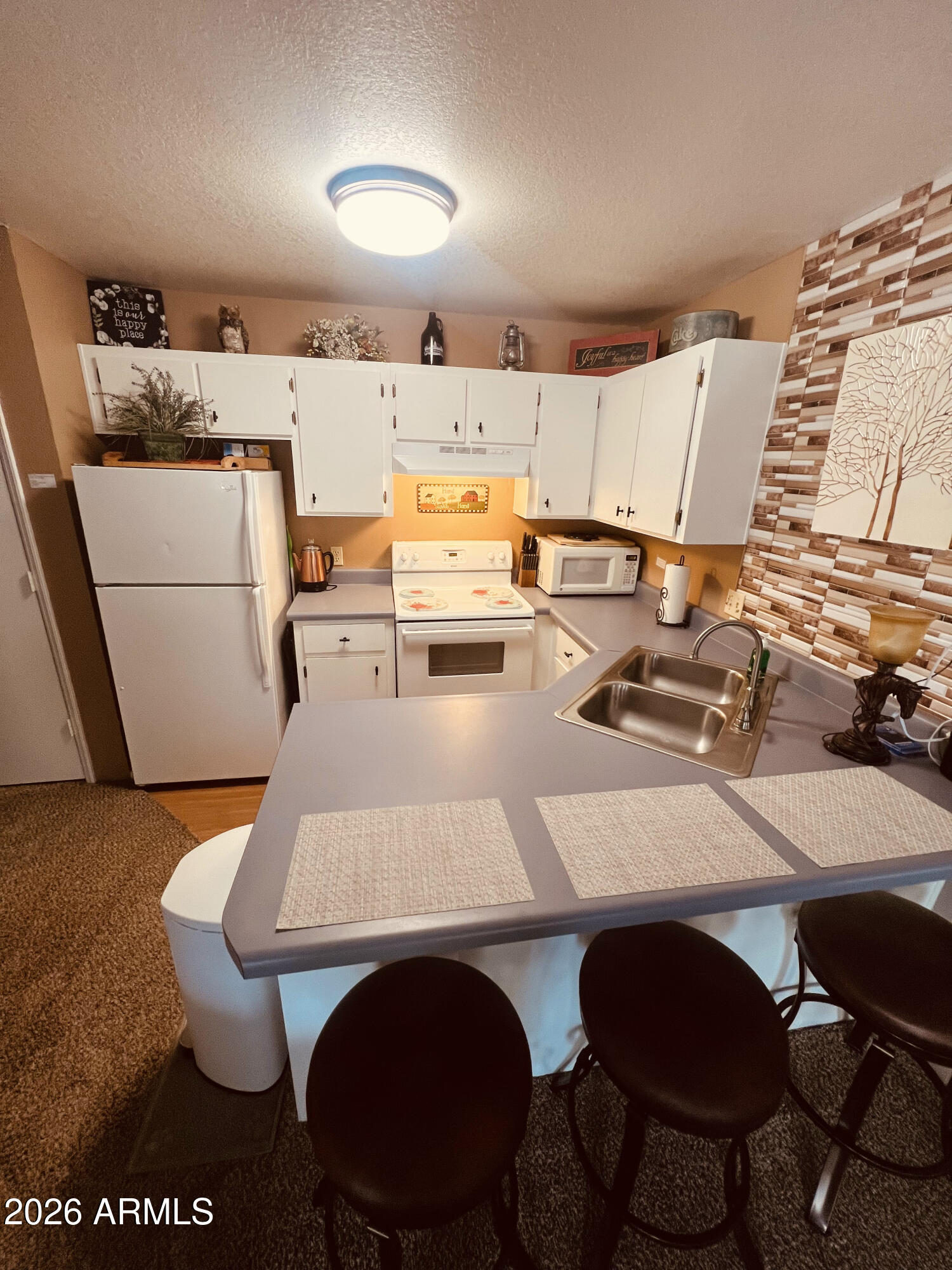 2700 South White Mountain Road, Unit 1126 Show Low, AZ 85901 - Photo 32 of 32 a view of kitchen with dining area and chandelier