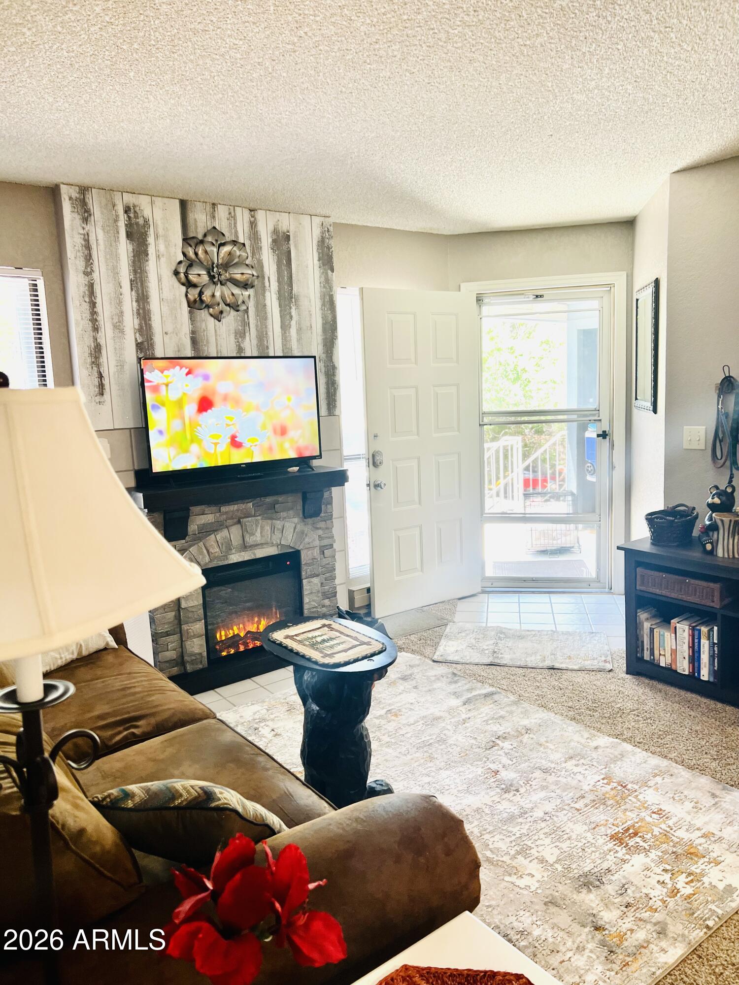 2700 South White Mountain Road, Unit 1126 Show Low, AZ 85901 - Photo 5 of 32 a living room with furniture a flat screen tv and a fireplace