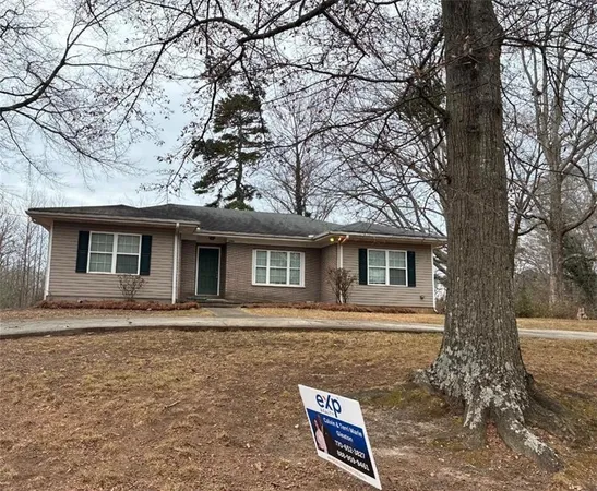 a front view of a house with trees