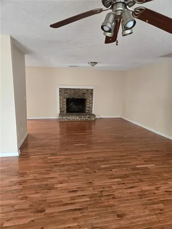 a view of a room with wooden floor and cabinets
