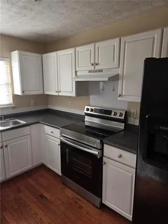 a kitchen with cabinets appliances and a sink