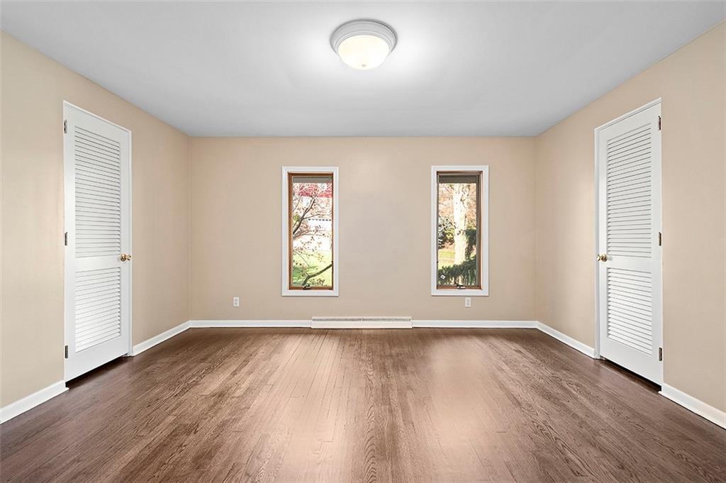801 Elm Spring Road Pittsburgh, PA 15243 - Photo 12 of 25 an empty room with wooden floor and windows