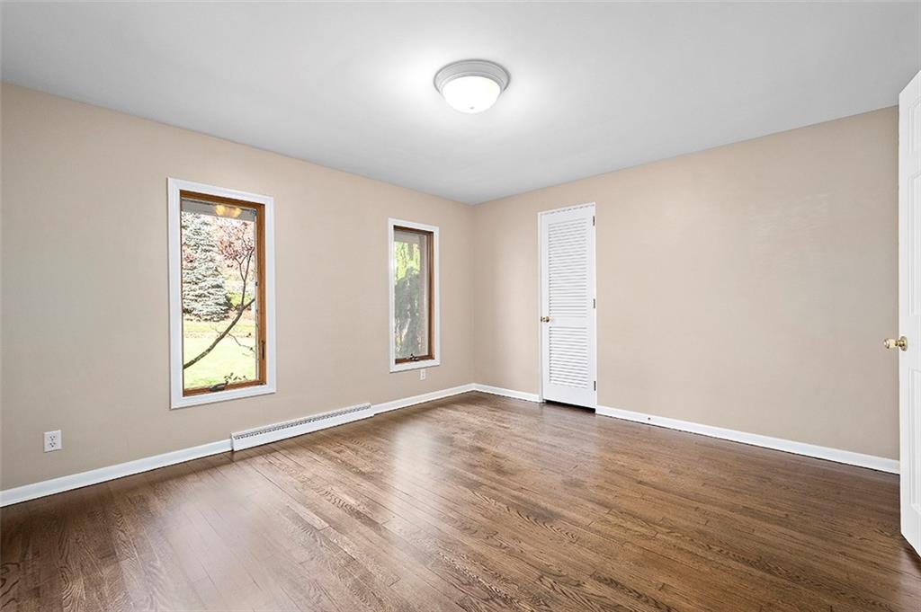 801 Elm Spring Road Pittsburgh, PA 15243 - Photo 13 of 25 an empty room with wooden floor and windows