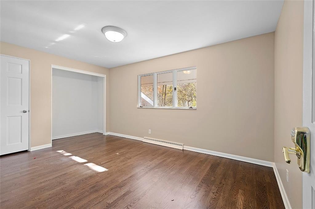 801 Elm Spring Road Pittsburgh, PA 15243 - Photo 14 of 25 an empty room with wooden floor and windows