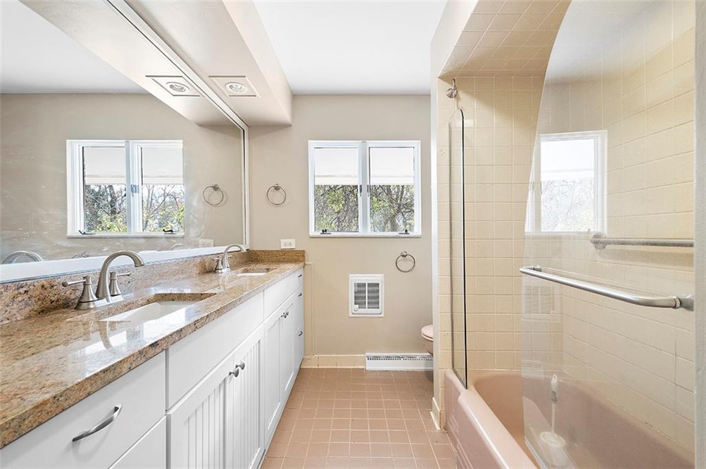 801 Elm Spring Road Pittsburgh, PA 15243 - Photo 15 of 25 a bathroom with a granite countertop sink a mirror and a bathtub