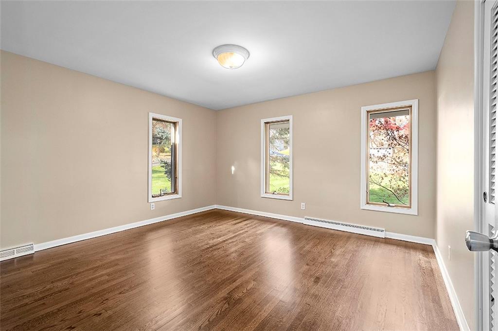 801 Elm Spring Road Pittsburgh, PA 15243 - Photo 16 of 25 a view of an empty room with wooden floor and a window