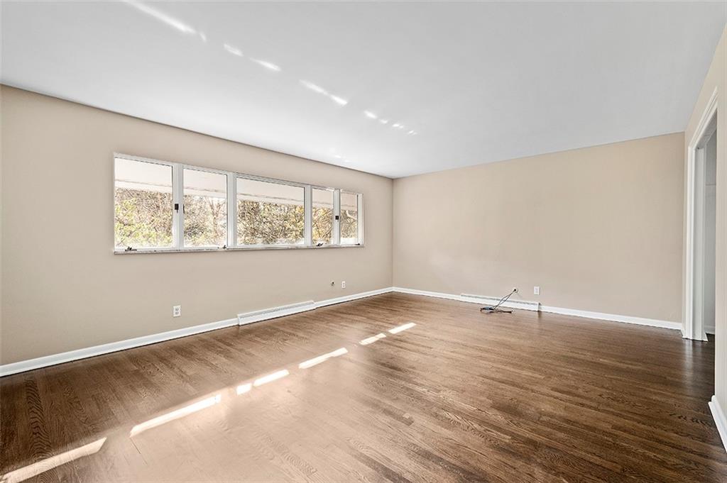 801 Elm Spring Road Pittsburgh, PA 15243 - Photo 18 of 25 a view of an empty room with wooden floor and a window