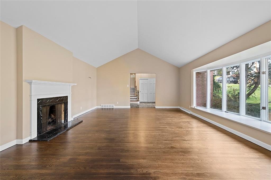 801 Elm Spring Road Pittsburgh, PA 15243 - Photo 5 of 25 a view of empty room with wooden floor and fireplace