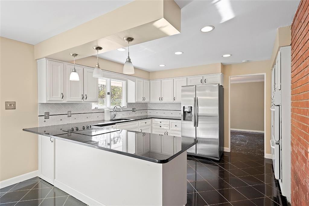 801 Elm Spring Road Pittsburgh, PA 15243 - Photo 7 of 25 a kitchen with granite countertop a sink and stainless steel appliances
