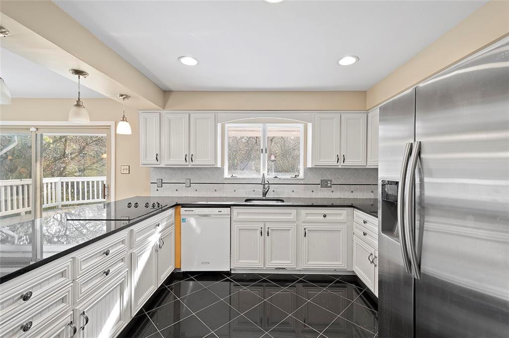 801 Elm Spring Road Pittsburgh, PA 15243 - Photo 8 of 25 a kitchen with granite countertop white cabinets and white appliances