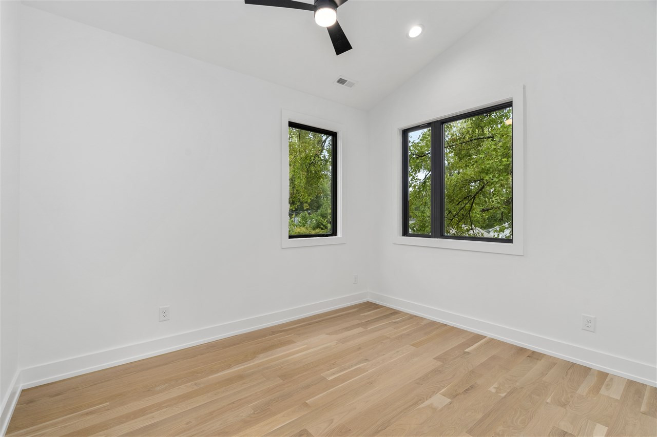 1600 Glendale Avenue Durham, NC 27701 - Photo 24 of 29 an empty room with wooden floor and windows