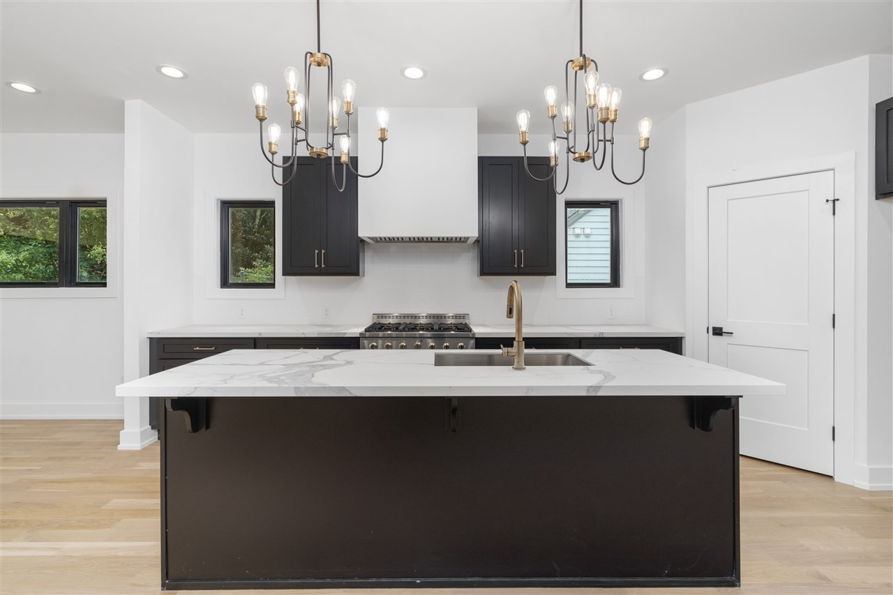 1600 Glendale Avenue Durham, NC 27701 - Photo 5 of 29 a view of a kitchen with granite countertop a sink dishwasher a dining table and chairs