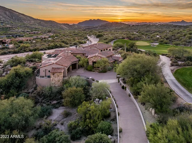 an aerial view of residential houses with outdoor space and mountain view