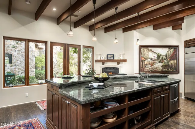 a view of a patio with table and chairs and potted plants