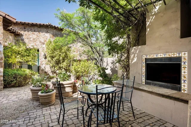 a living room with furniture a large window and a fireplace