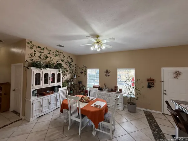 a living room with furniture a chandelier and a dining room