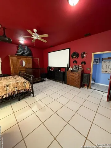 a bedroom with furniture and a flat screen tv