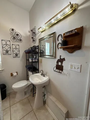 a bathroom with a toilet a sink and mirror