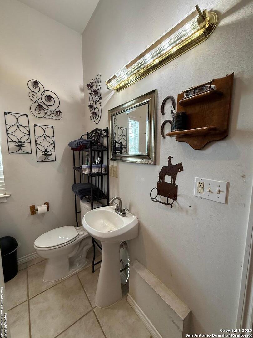 1077 C Road Sutherland Springs, TX 78161 - Photo 18 of 45 a bathroom with a toilet a sink and mirror