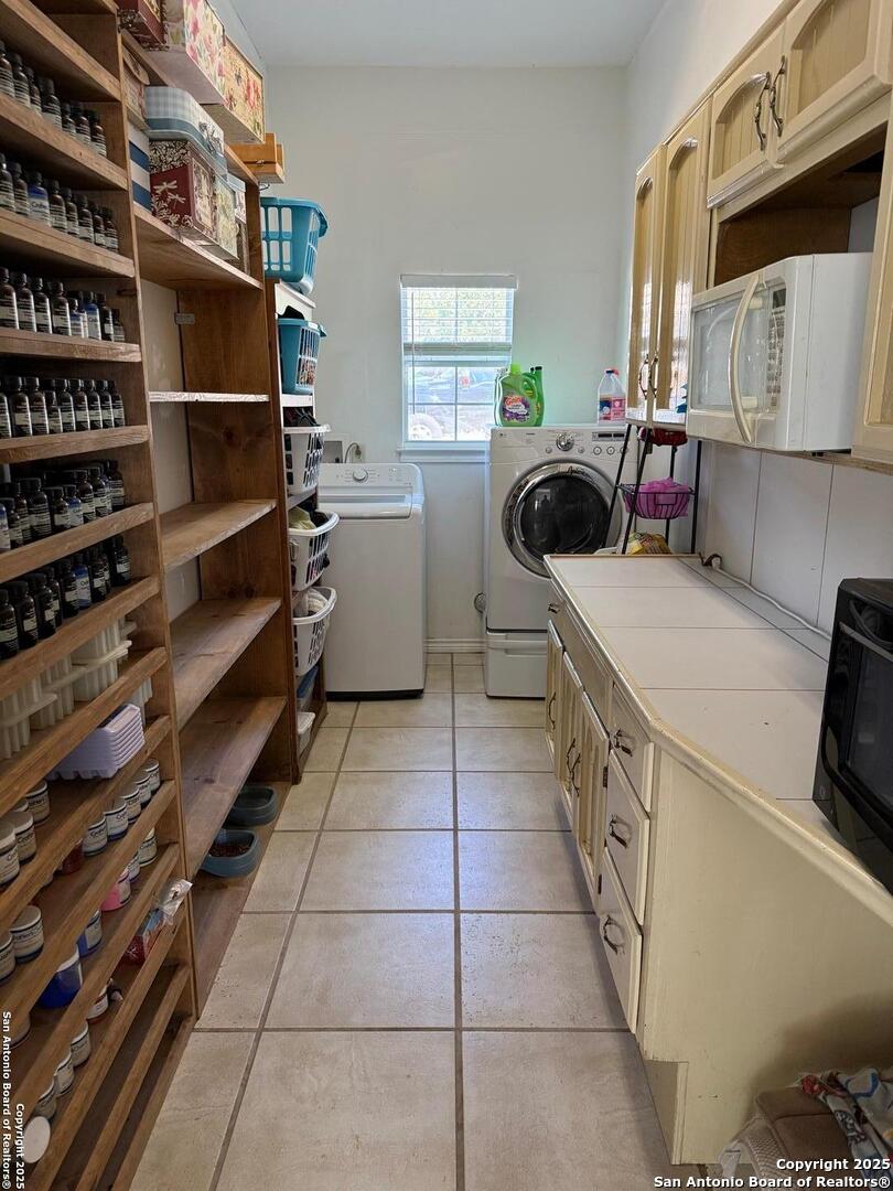 1077 C Road Sutherland Springs, TX 78161 - Photo 21 of 45 a kitchen with a sink a stove and a cabinets