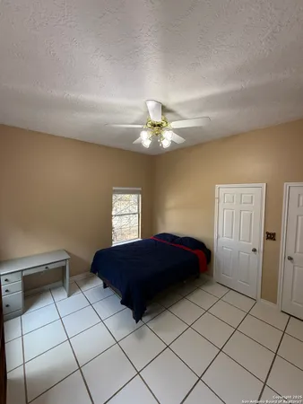 a bedroom with a bed and a lamp