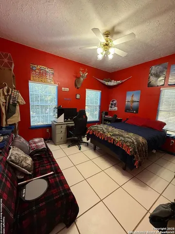 a bedroom with furniture and a chandelier