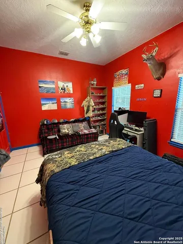 a bed sitting in a bedroom next to a window