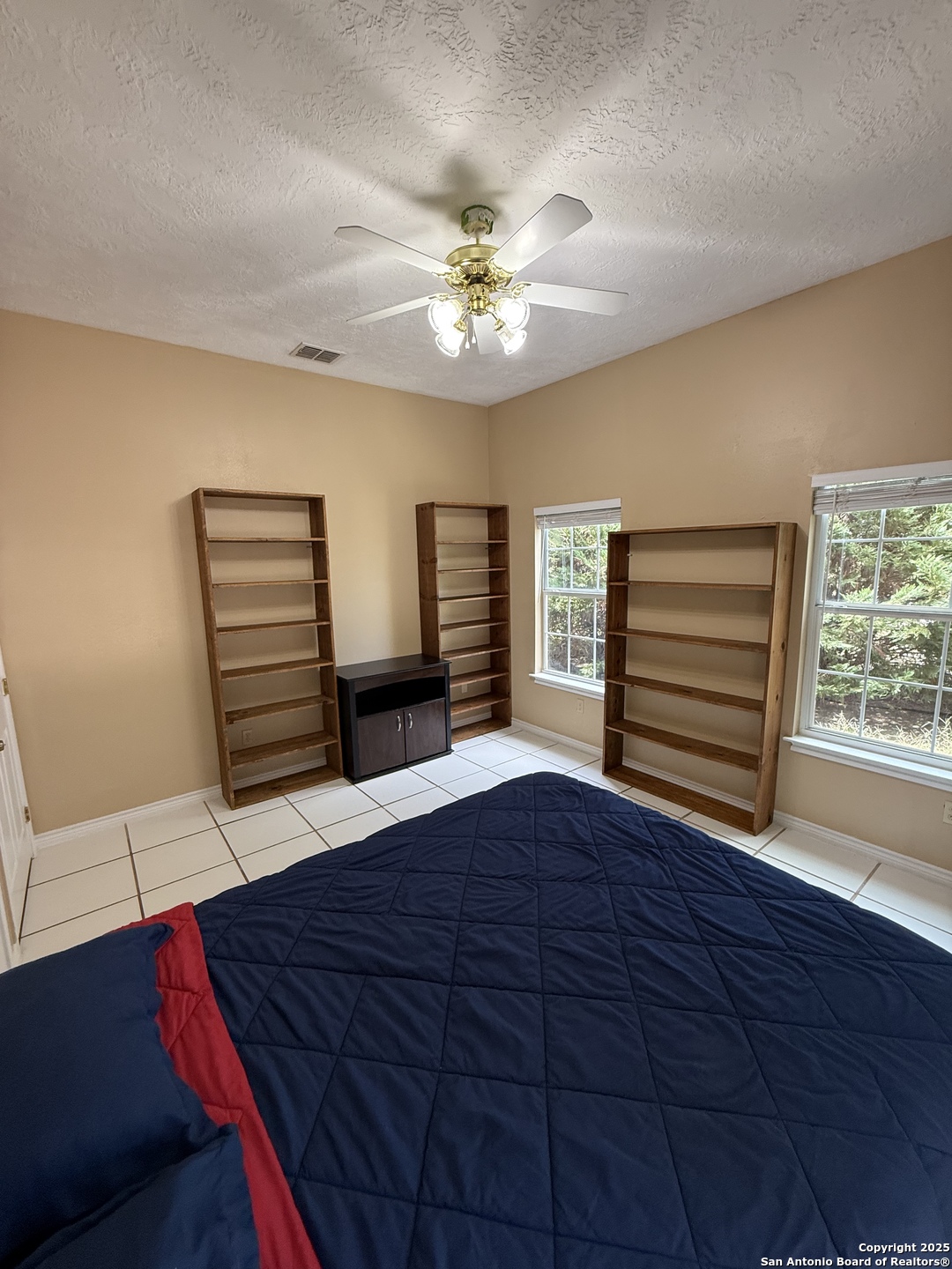 1077 C Road Sutherland Springs, TX 78161 - Photo 31 of 45 a bedroom with a bed and a chandelier