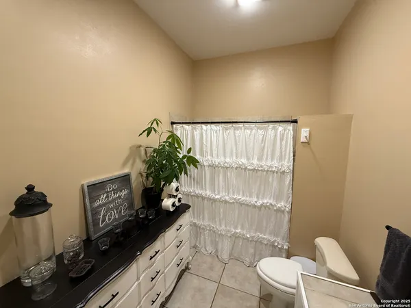a bathroom with a toilet a sink and a mirror