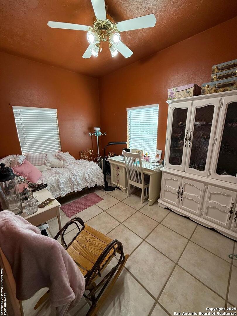 1077 C Road Sutherland Springs, TX 78161 - Photo 41 of 45 a bedroom with furniture and a chandelier