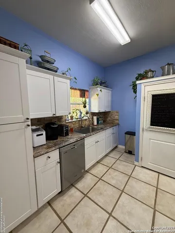 a kitchen with a sink a stove and cabinets