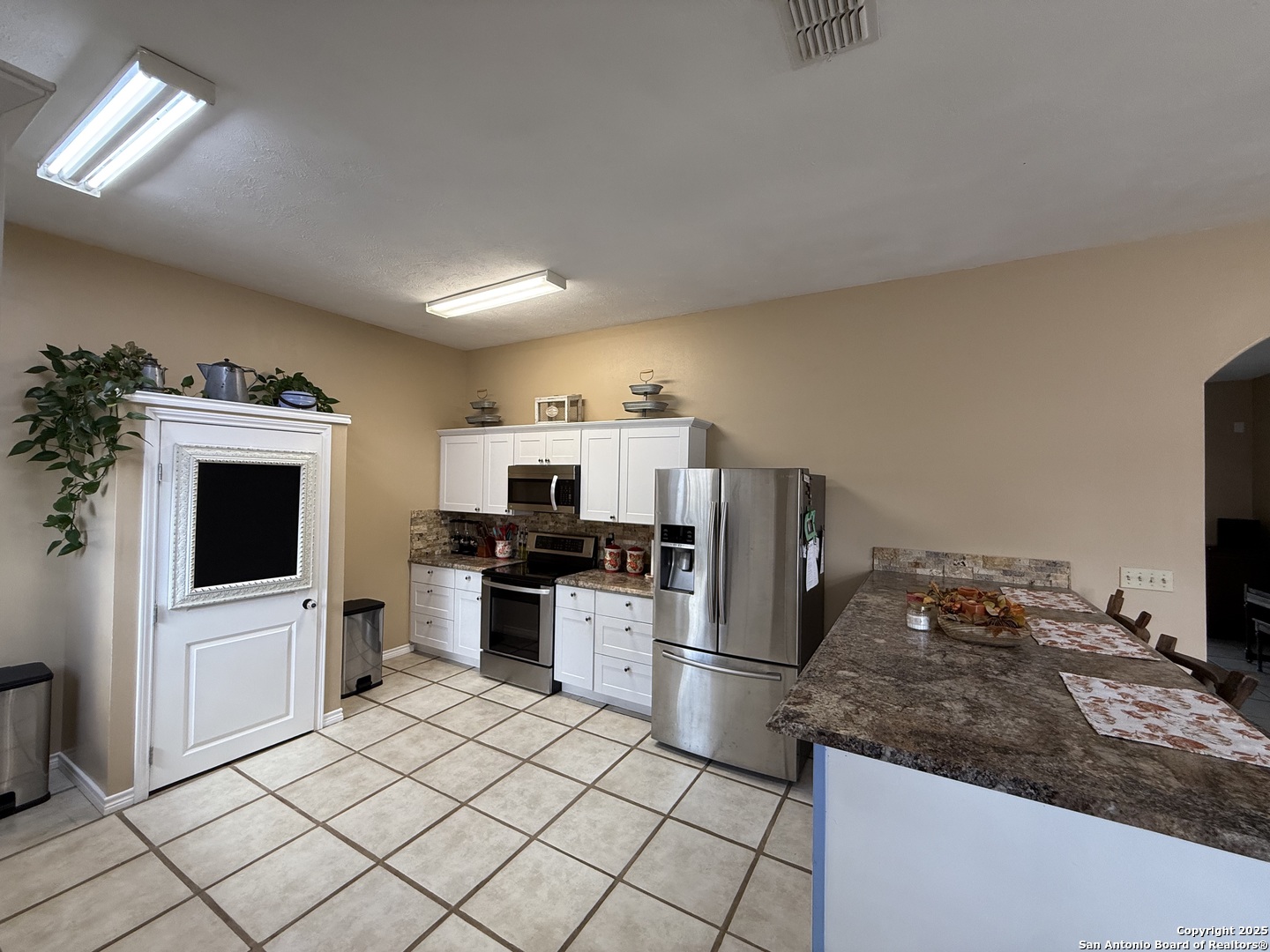 1077 C Road Sutherland Springs, TX 78161 - Photo 7 of 45 a kitchen with stainless steel appliances a stove a microwave and a refrigerator