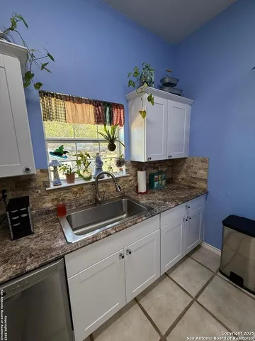 a kitchen with granite countertop a sink and a stove