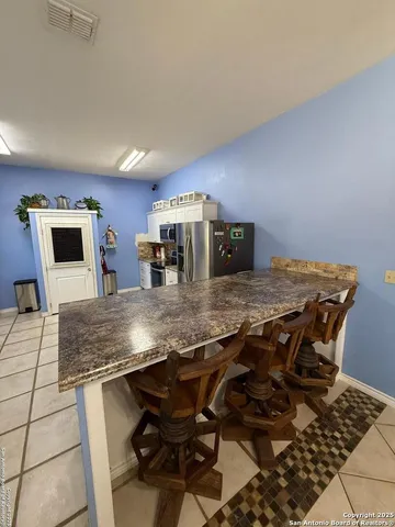 a view of a dining room kitchen counter top space and wooden floor