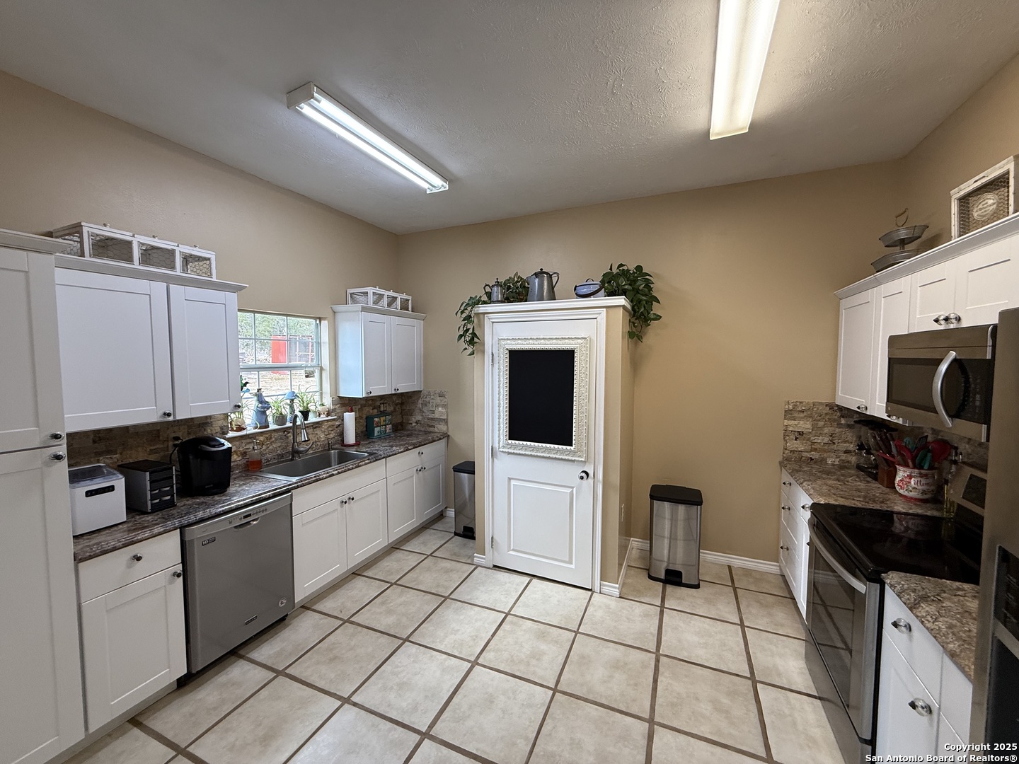 1077 C Road Sutherland Springs, TX 78161 - Photo 8 of 45 a kitchen with stainless steel appliances a stove a sink and a microwave