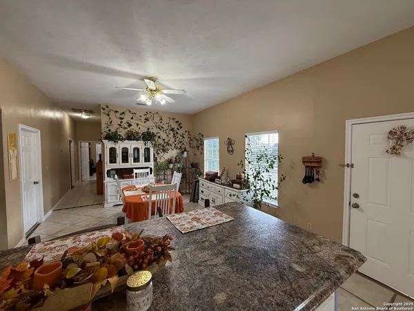 a living room with furniture a chandelier and a dining table