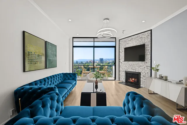 a living room with furniture fireplace and flat screen tv
