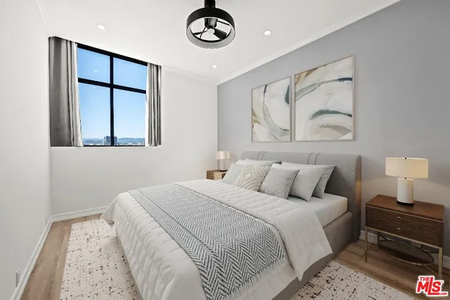 a bedroom with a bed and a painting on the wall