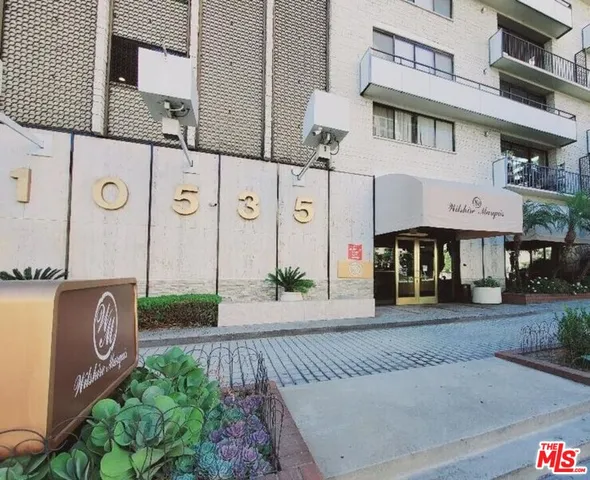 a hallway with furniture and a potted plant