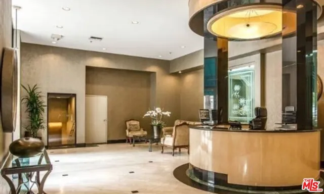 a vase of flowers sitting on a table with a potted plant