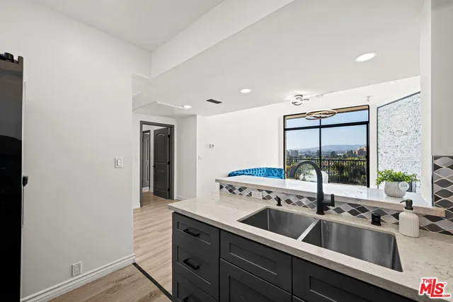 a kitchen with a sink and a refrigerator