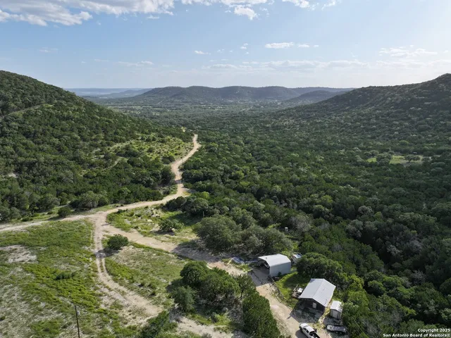 a view of a lush green hillside and houses