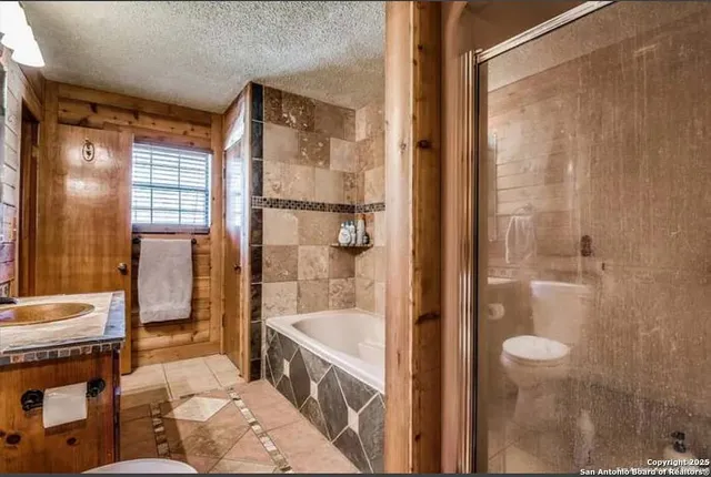 a bedroom with a bed and large windows